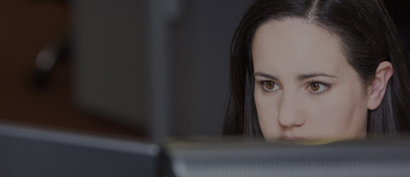 Team member concentrating behind computer | Paycheck Plus providers of outsource payroll services