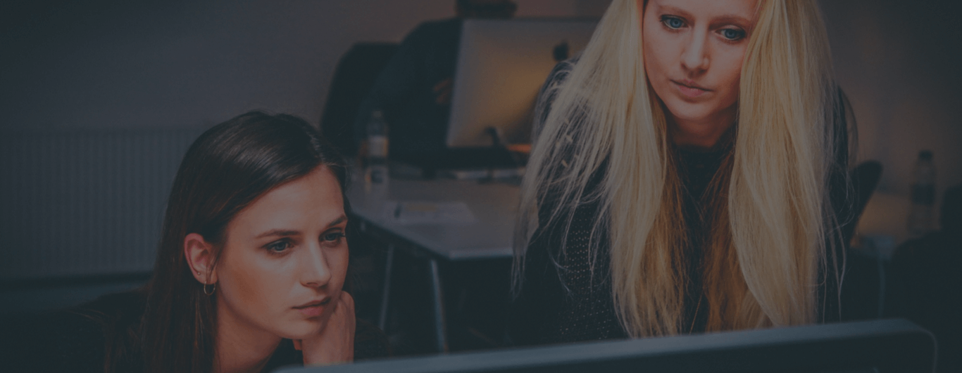 Two women in an office looking at a PC | Tailored Payroll Management with Paycheck Plus